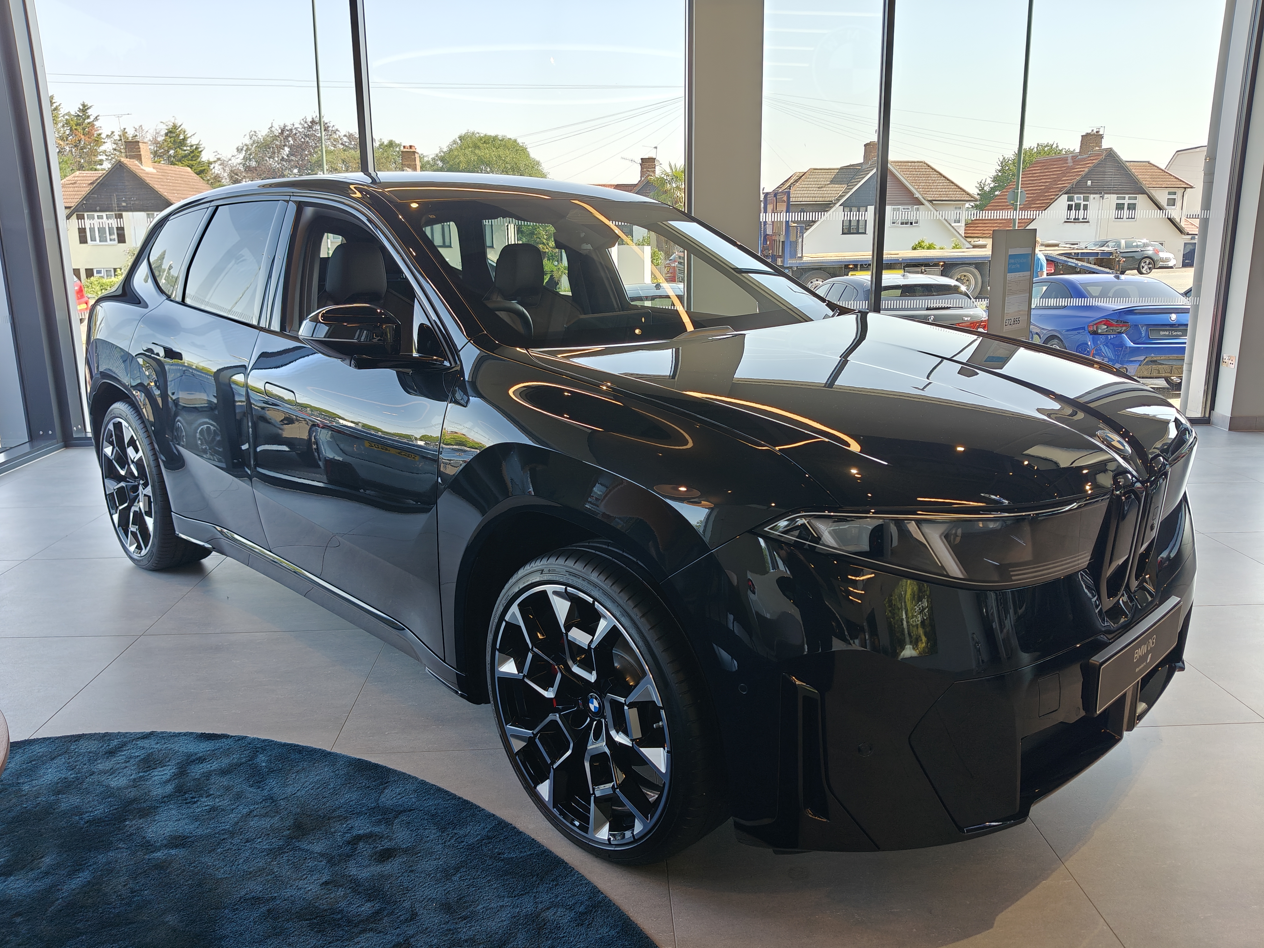 BMW iX3 50 xDrive M Sport Pro in Black Sapphire - front three-quarter view in Hedin Ruxley showroom
